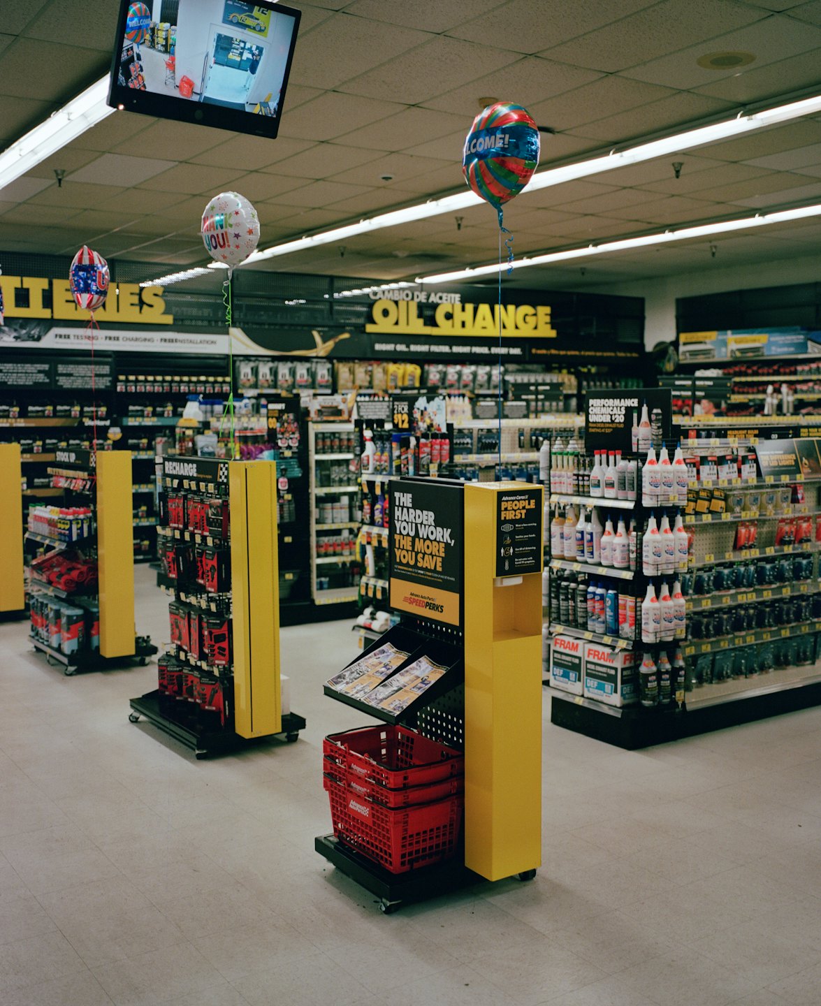 An auto parts store with aisles of automotive products on shelves.