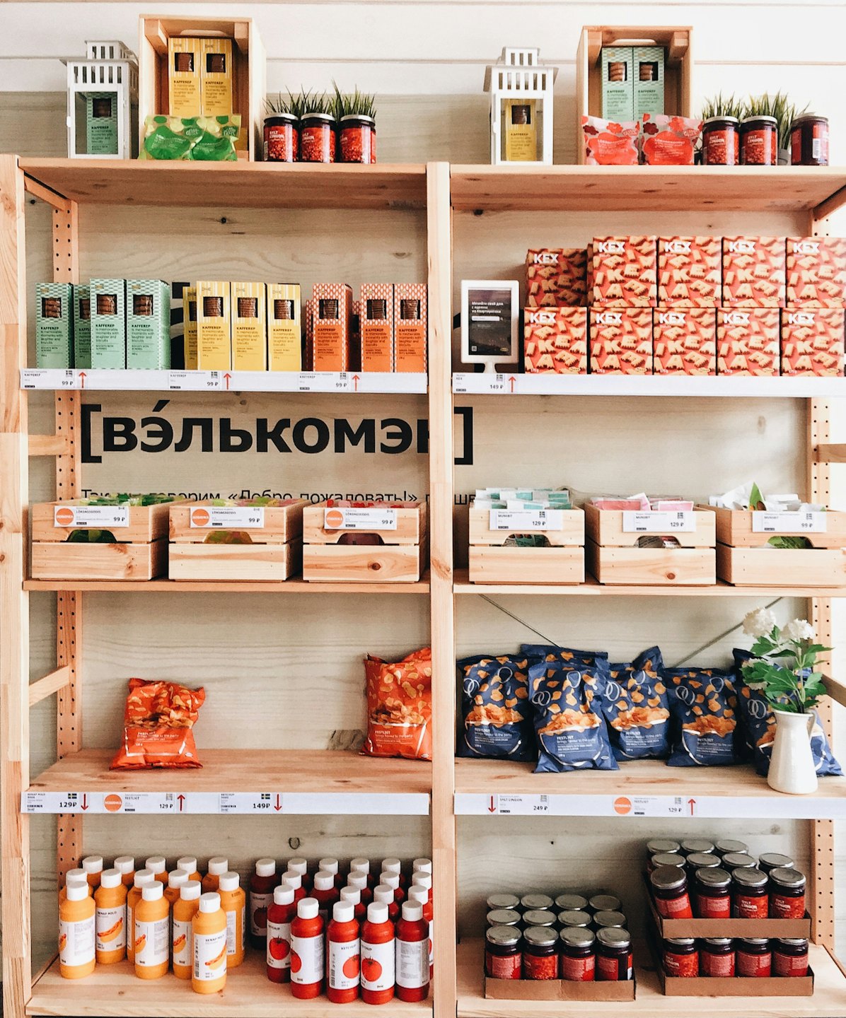 Wooden shelves stocked with various packaged food items in a shop.